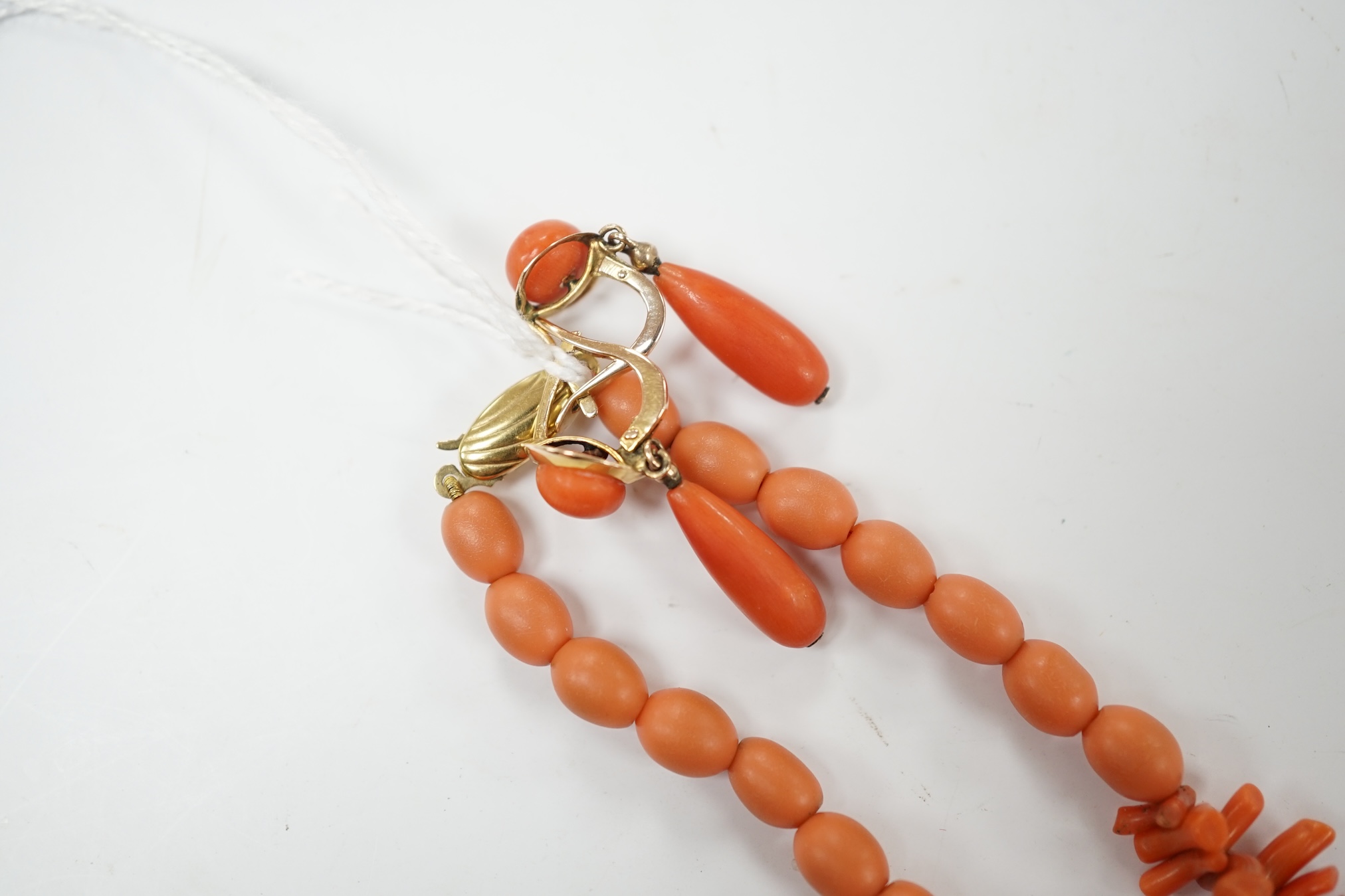 A single strand coral bead and branch necklace, with 375 clasp, 42cm, together with a pair of yellow metal and two stone coral bead drop earrings. Condition - fair